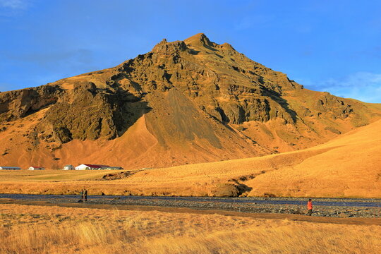 Landscape near Skogafoss, with trail to an observation platform above it in south Iceland