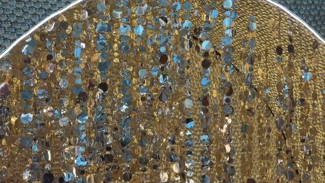 4K footage of sparkling tassels, tinsels, slingers hanging from ceiling. Decoration and embellishment for festival and seasons greetings. Reflective and mirror tassels 