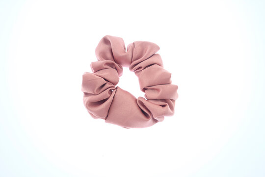 stylish pink scrunchie trendy hair accessory for all hair types, pink scrunchie, accessory, trendy scrunchie, fashionable hair tie, soft fabric scrunchie, elastic material isolated on white background