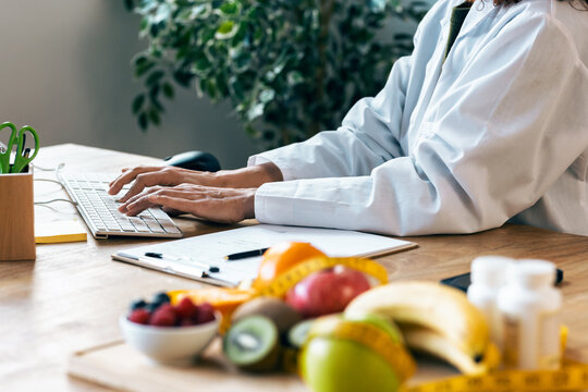 Nutritionist woman doing working with computer in the hospital consultation