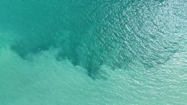 Aerial View of Two Distinct Shades of Turquoise Ocean Water Meeting, Creating a Natural Abstract Pattern on the Sea Surface