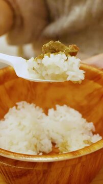 Close Up of Person Eating Japanese Crab Miso with Rice in Osaka