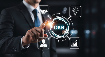 Obraz premium Businessman touching OKR icon for objectives and key results management strategy