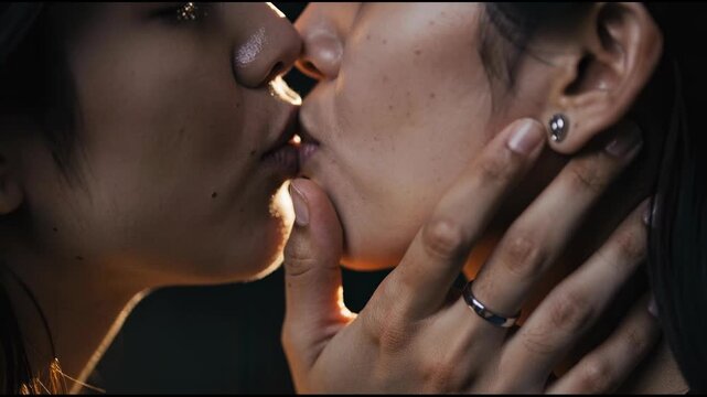 Close up of intimate romantic kiss between two people expressing love and affection