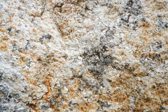 Close up of weathered granite surface texture. Coarse grain crystal rock