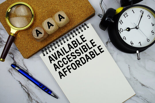 AAA Available, Accessible, Affordable text written on notepad with magnifying glass and alarm clock on marble background