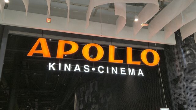 Vilnius Lithuania 21.03.2026 Apollo kinas cinema illuminated sign in modern shopping mall interior with entertainment venue branding and dark stylish design elements