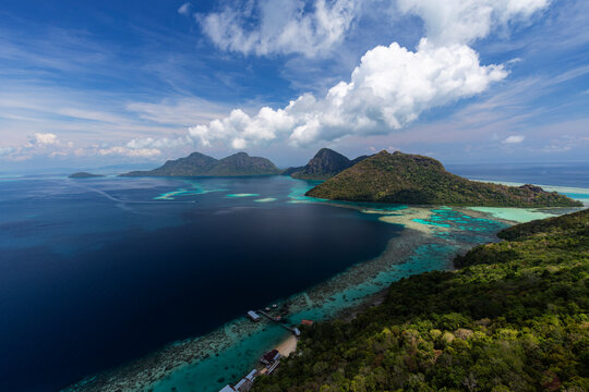 Optimized Title: Majestic panoramic view of tropical islands, vibrant coral reefs, and turquoise lagoon from the peak of Bohey Dulang, Tun Sakaran Marine Park, Sabah, Malaysia