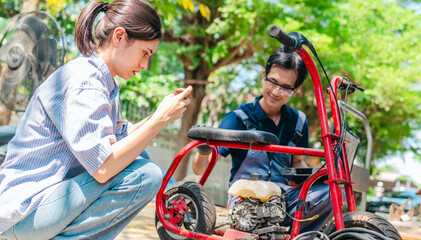 Naklejka premium Female Startup Founder and Engineer Test Minibike Prototype at Small Business Workshop
