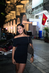 Fototapeta premium Thai Woman on Hanoi Street with Vietnam Flag