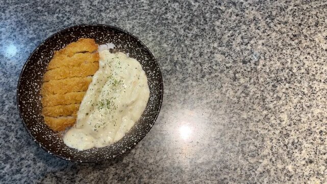 top view of Hokkaido Dori Donburi isolated on ceramic table. light, lights. bright. lamp, lamps. white. copy space, empty, free, negative, text, design. black and white bowl. Rice with dory fish