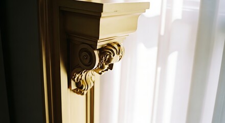 Obraz premium Close-up of Elegant Ornate Golden Architectural Corbel with Carved Face Mascaron Detail