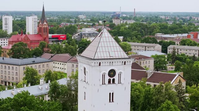 Cinematic orbit shot of Jelgava church tower with urban background Latvia