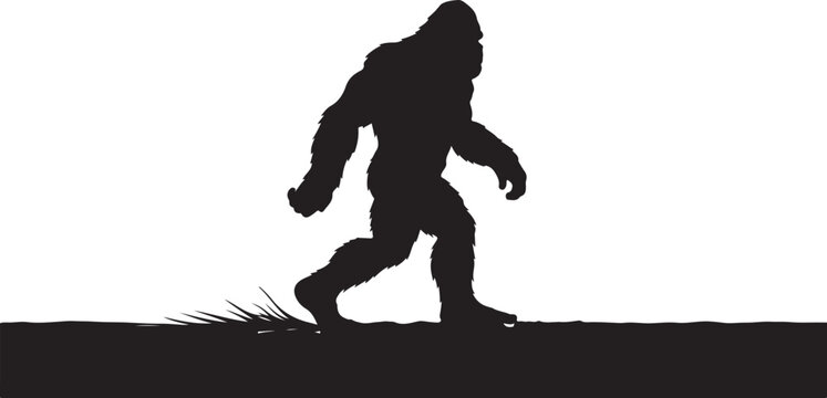 Bigfoot walking on a grassy field at sunset silhouette
