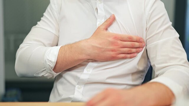 Person experiencing intense chest pain and discomfort. Depicts potential health issue, conveying feelings of unease, illness, and needing urgent medical attention or care.