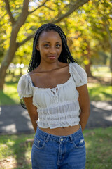 Naklejka premium Young black female outside in a park