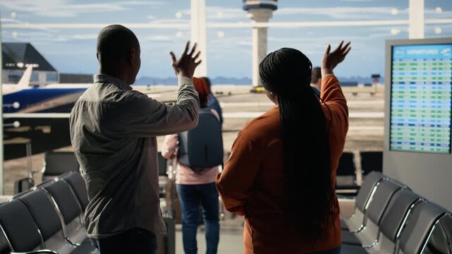Relieved comic parents waving goodbye to daughter and sharing high-five, celebrating empty nest milestone with upbeat lighthearted expressions. Job done concept and freedom in airport.