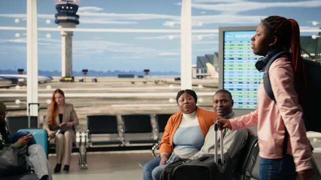 Agitated teenager daughter eager to leave on holiday with parents, fidgeting and being impatient about boarding the plane. Young black child with backpack excited and nervous, youth innocence.