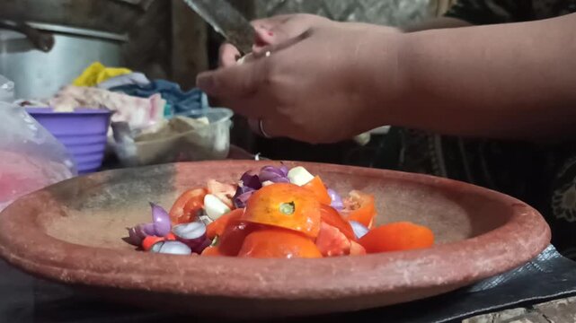 A food preparation process of peeling shallots to be used as a key ingredient in making traditional Indonesian sambal.
