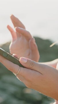 Outdoor, scroll or hands with phone for internet, check camera roll or social media post for holiday. Search chat history, typing or woman with mobile in nature, browsing online or vacation research
