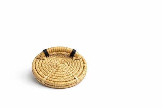 Bamboo printmaking baren with spiral braided surface and heritage studio character isolated on white background