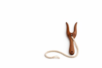 Naklejka premium Carved walnut lucet fork with fine linen braid and textile heritage detail isolated on white background