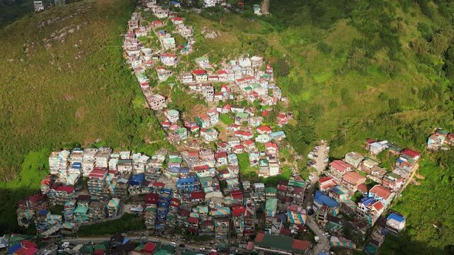 Picturesque aerial view of hillside residential settlement with lush greenery and vibrant, colorful rooftops - Benguet, Philippines