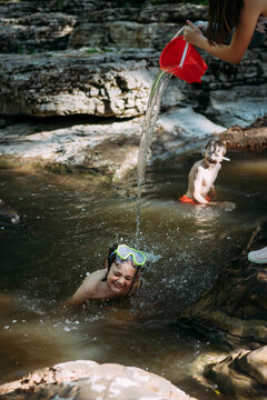 Playful kids cooling off on summer afternoon