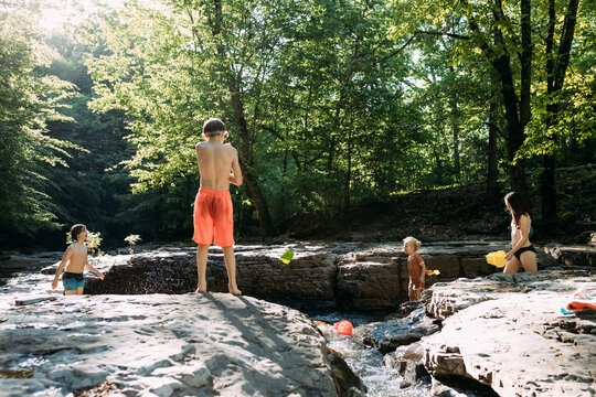 Children playing together in rocky spring