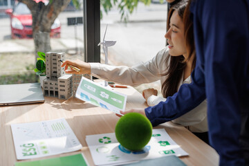 Businesswomen analyzing sustainable urban planning project © crizzystudio
