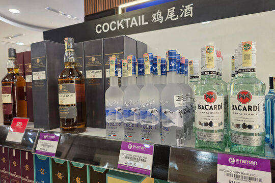 Bayan Lepas, Malaysia - Jan 21, 2026: Bottles of Grey Goose vodka, Bacardi Carta Blanca rum, and Glen Deveron scotch whisky on a display shelf at Penang International Airport duty free shop.