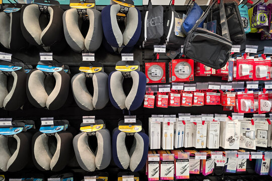 Bayan Lepas, Malaysia - Jan 21, 2026: A retail wall at a WHSmith store in Penang International Airport featuring memory foam neck pillows, travel adapters, and electronic accessories for travelers.