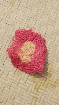 String hoppers close up still life on bamboo woven mat background with pink border authentic sri lankan cuisine