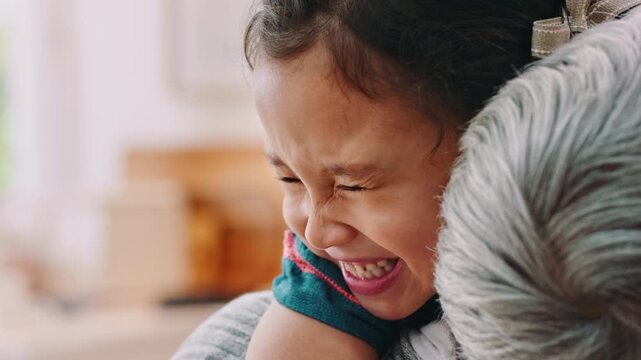 Grandmother, girl and hug in home with smile, bonding together and support for family connection. Happy, senior woman and grandchild embrace in house with affection, love and trust on weekend break.