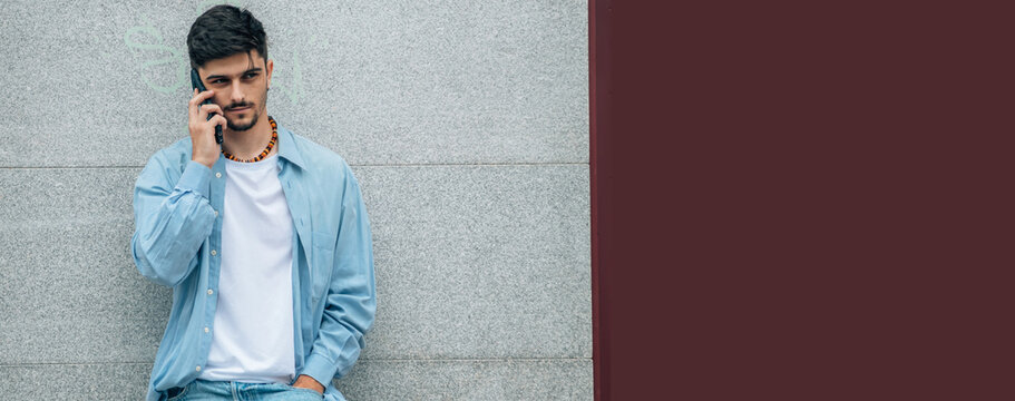 casual young man on the street with your mobile phone