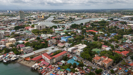 Fototapeta premium aerial drone shot of Iloilo City's river esplanade. Showcasing the winding Iloilo River and the vibrant urban texture of the City of Love in the heart of the Philippines