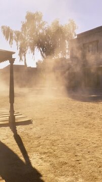 Abandoned Western Ghost Town in Tabernas Desert with Blowing Dust and Vintage Film Atmosphere
