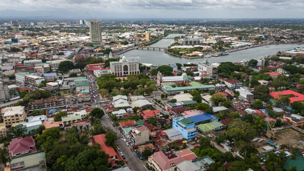 Obraz premium aerial drone shot of Iloilo City's river esplanade. Showcasing the winding Iloilo River and the vibrant urban texture of the City of Love in the heart of the Philippines