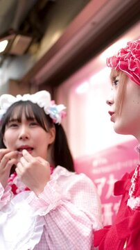 Two Young Women in Lolita Fashion Talking on Harajuku Street