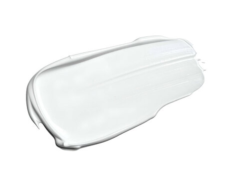 A thick, white cosmetic cream swatch is swirled against a dark background