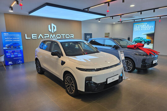 Penang, Malaysia - Feb 20, 2026: A white Leapmotor B10 and a grey Leapmotor C10 electric SUV displayed inside a brightly lit showroom.