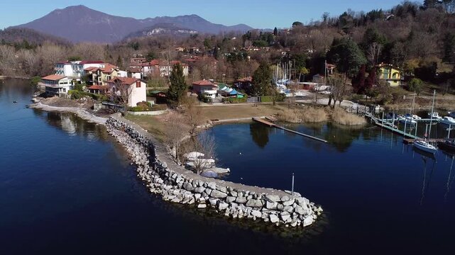 Aerial view of Sasso Moro harbor and Leggiuno lakeside village on Lake Maggiore, province of Varese, Lombardy, Italy