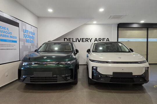 Penang, Malaysia - Feb 20, 2026: A dark green Leapmotor C10 and a white Leapmotor B10 electric SUV parked side by side in a designated delivery area of a car dealership.