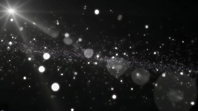 Abstract background of bright shimmering particles and light rays on a dark backdrop.