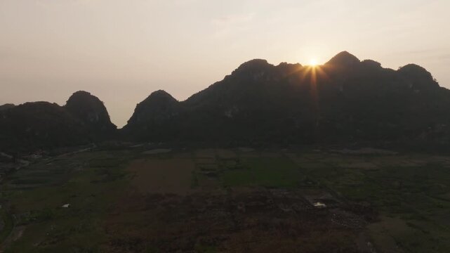 Cat Ba Vietnam aerial linger on warm sunrise or sunset over the bay, with subtle gradients and mirrored light.