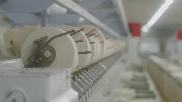 Close-Up of Yarn Spools in Textile Manufacturing Line with Depth of Field