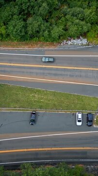 Vertical View Of Asphalt Road Through A Forest Near Mohawk Trail In Berkshire Hills Of Western Massachusetts, USA. Aerial Topdown Shot