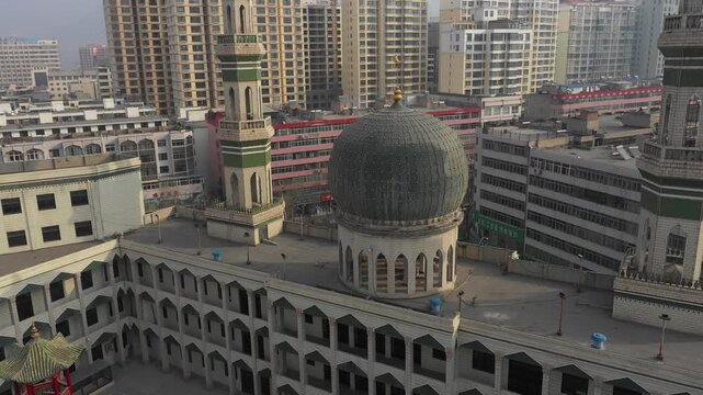Rotating drone shot of green domed Dongguan mosque in Xining, China
