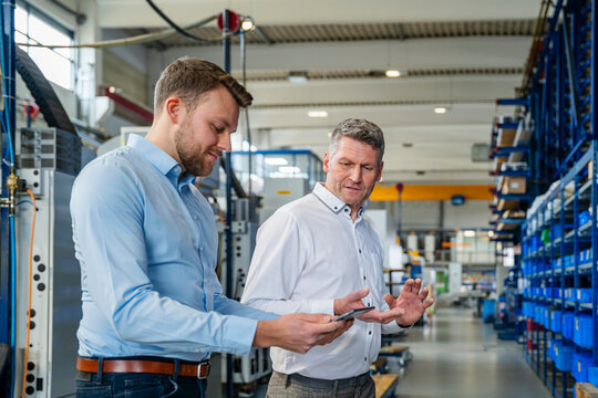 Business meeting between employees in a modern production hall