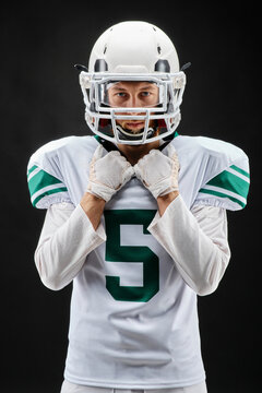 Portrait of American football player in helmet with number 5 jersey